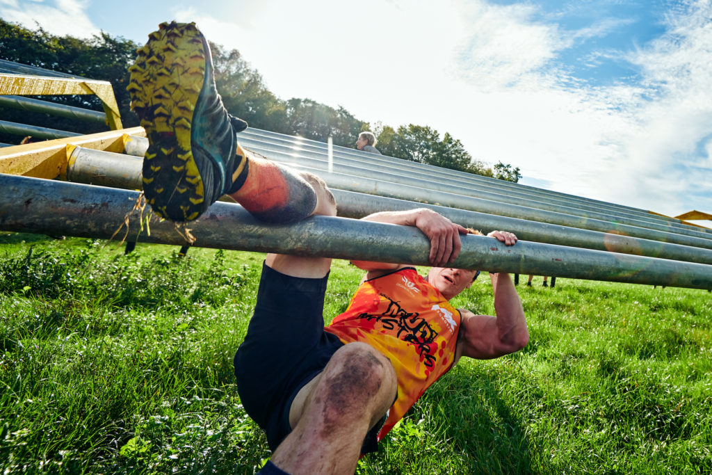 Man racing through obstacle course in UK.
