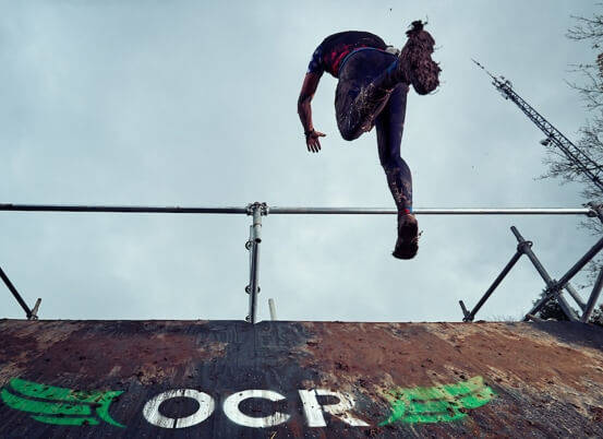 athlete jumping over obstacle
